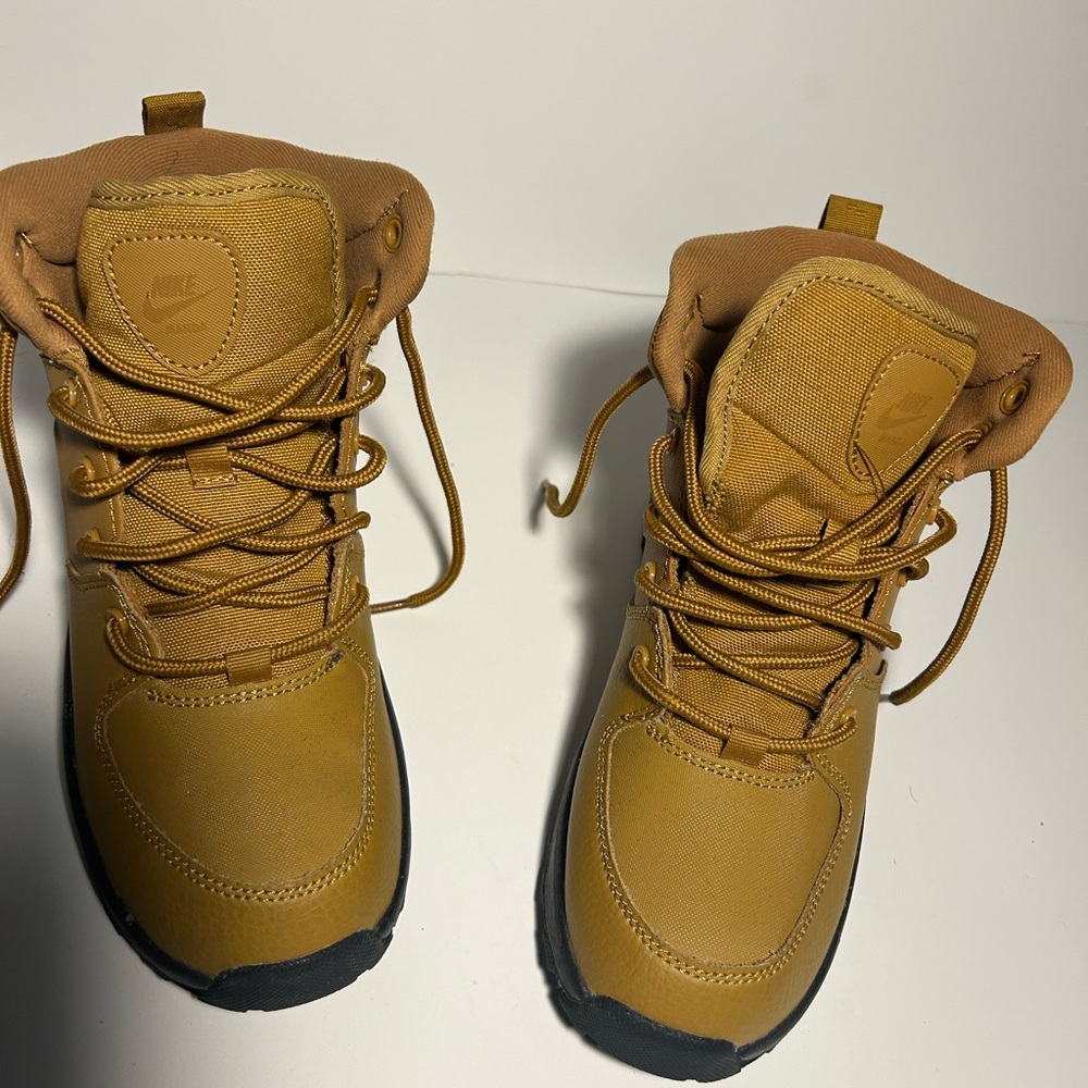 Gold and black nike boots